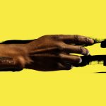 project image featuring a photo of Jawanza Williams' hand with tattoo that says "Metanoia" over black paint brush stroke on a saturated yellow background